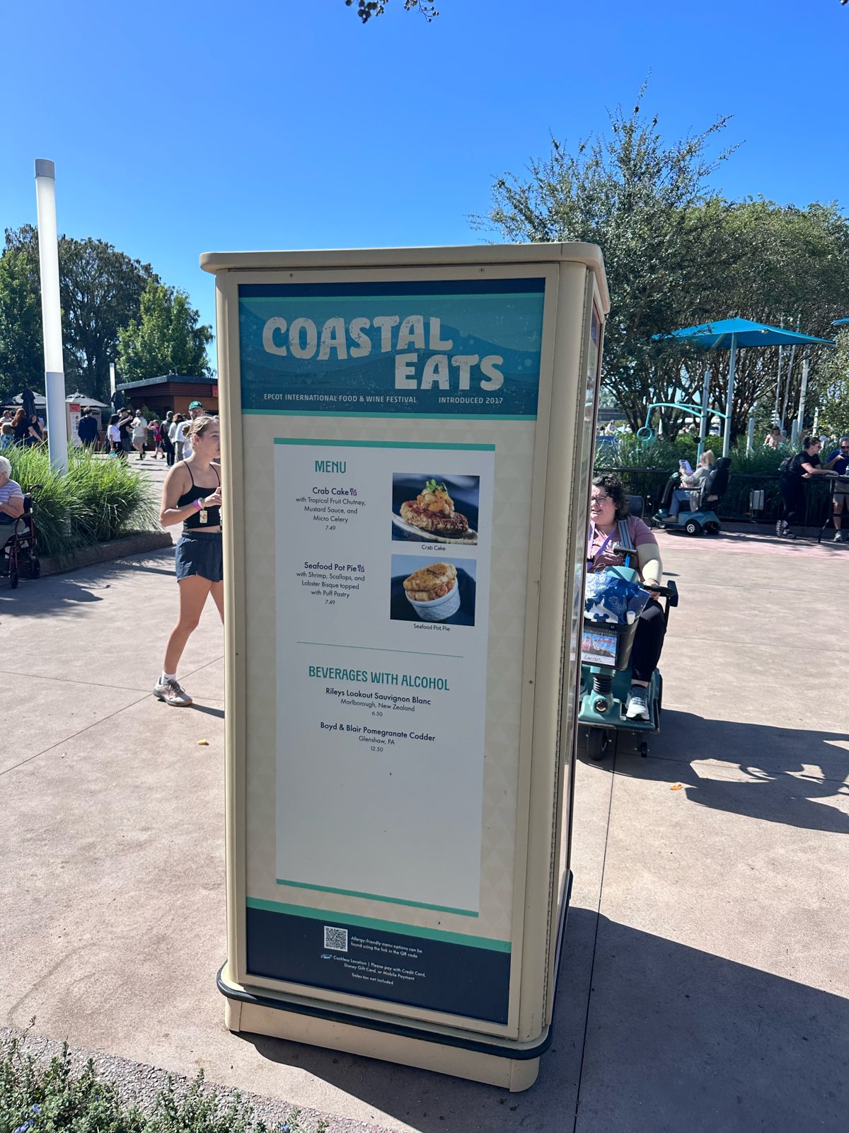 Coastal Eats menu board with crab cake and seafood pot pie at $7.49 each