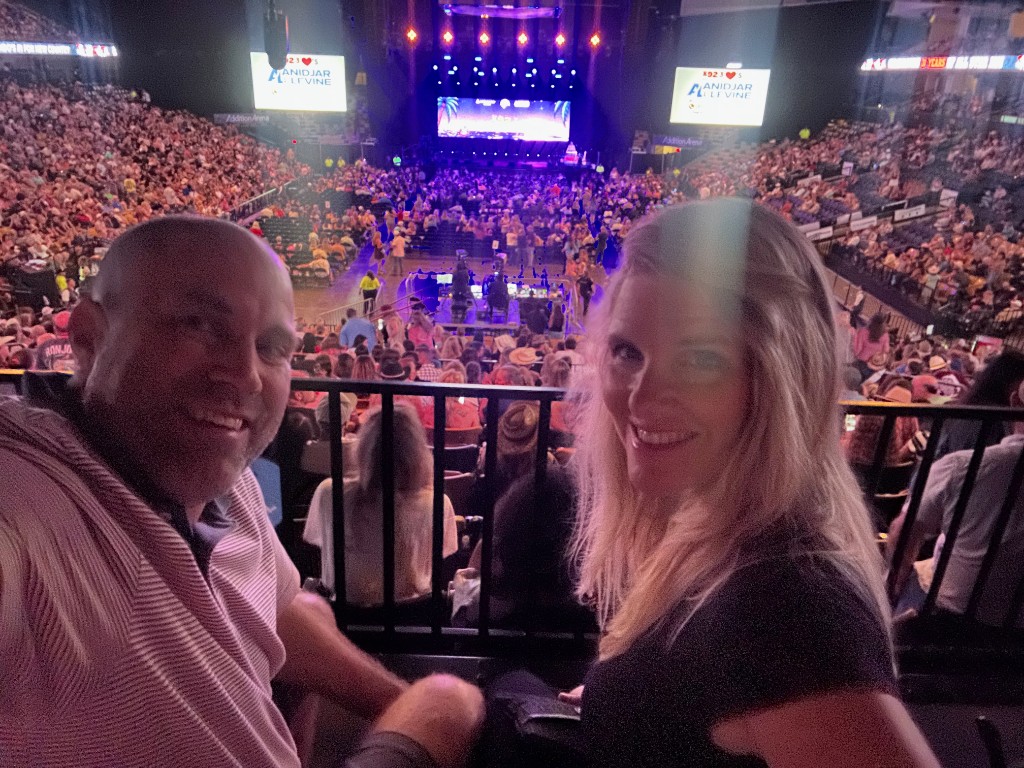 Ryan and Sarah in the arena with the K92.3 All Star Jam stage ahead