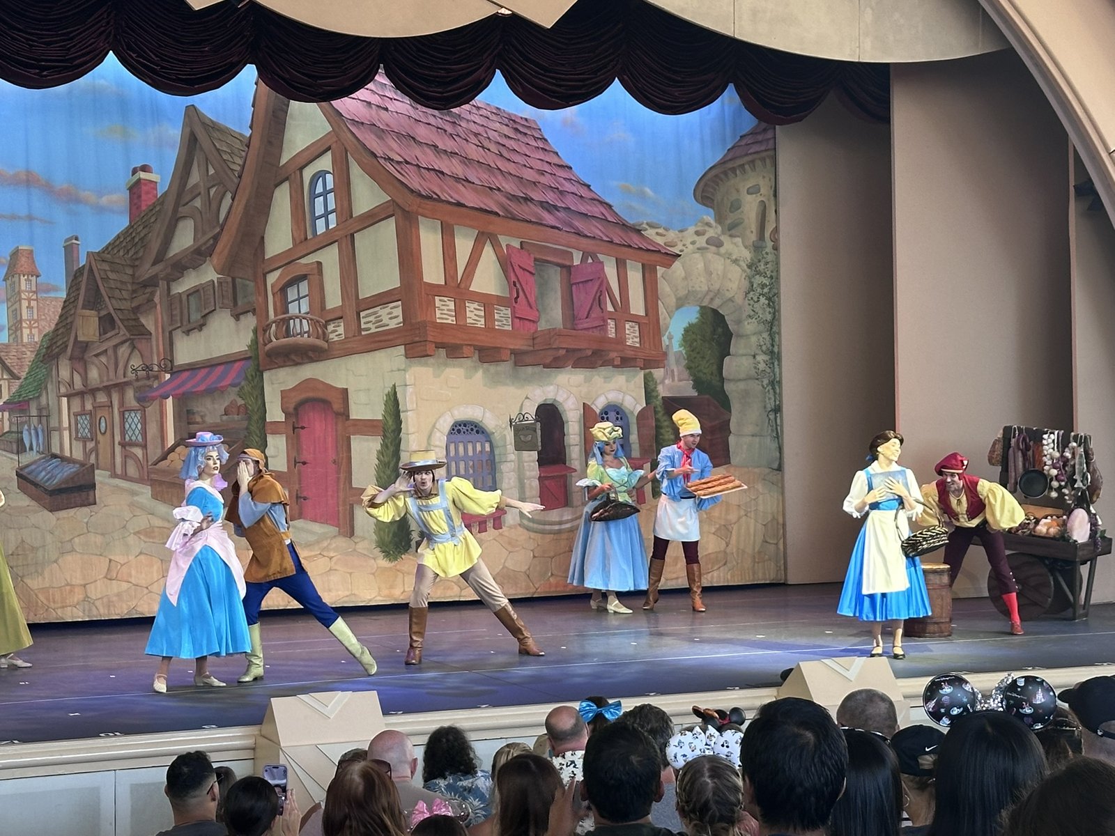 Belle and townspeople in the village opening number