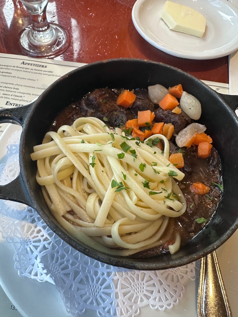 Boeuf Bourguignon in a cast-iron cocotte with noodles