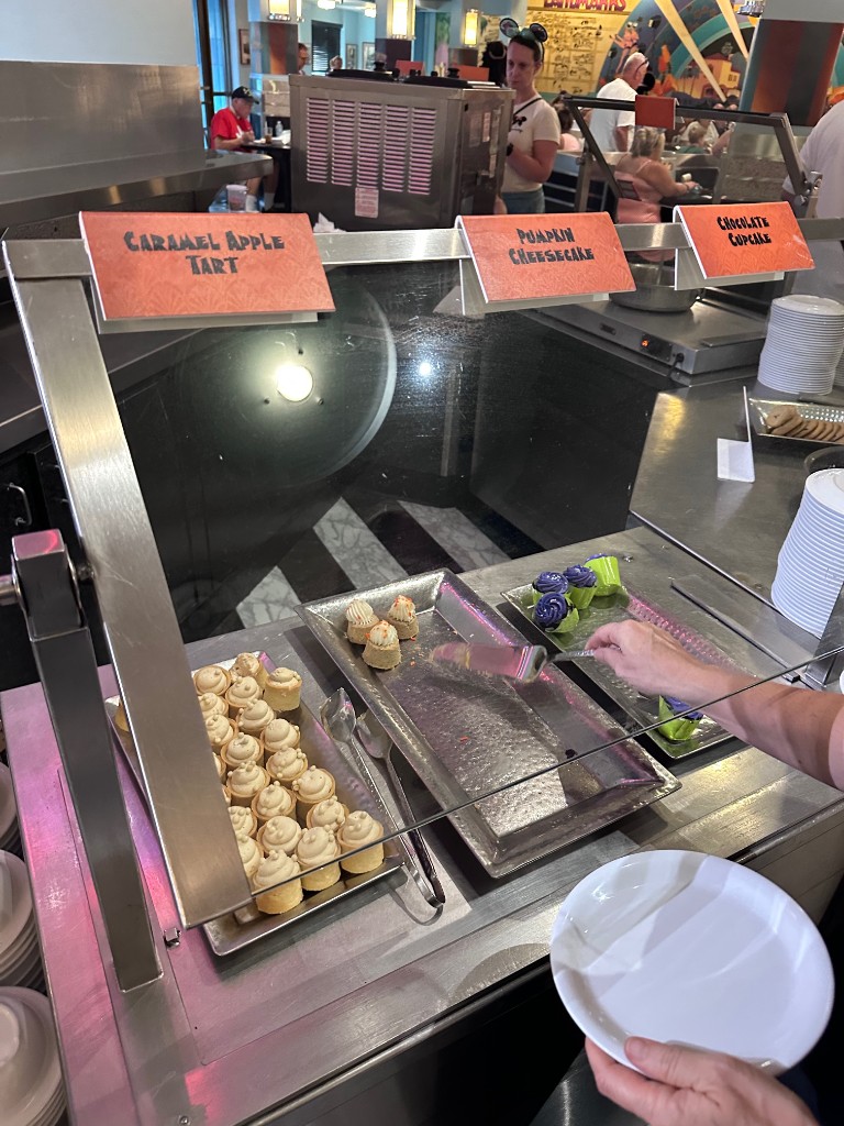 Halloween dessert buffet — caramel apple tart, pumpkin cheesecake, chocolate cupcakes