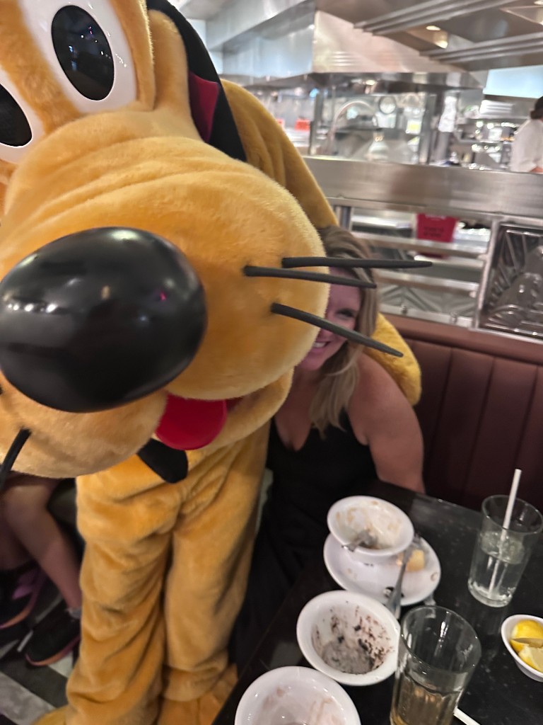 Sarah with Pluto at the table during dinner