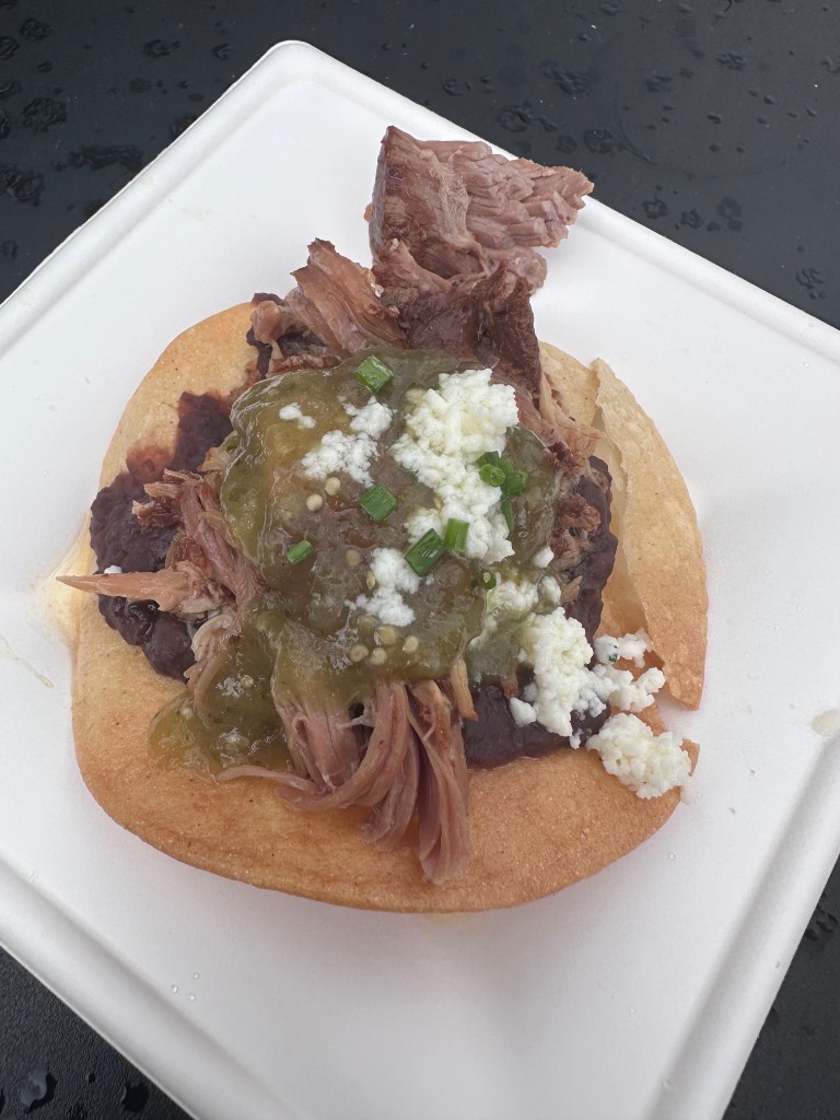 Mexico Food and Wine tostada with shredded meat, salsa verde, and cheese