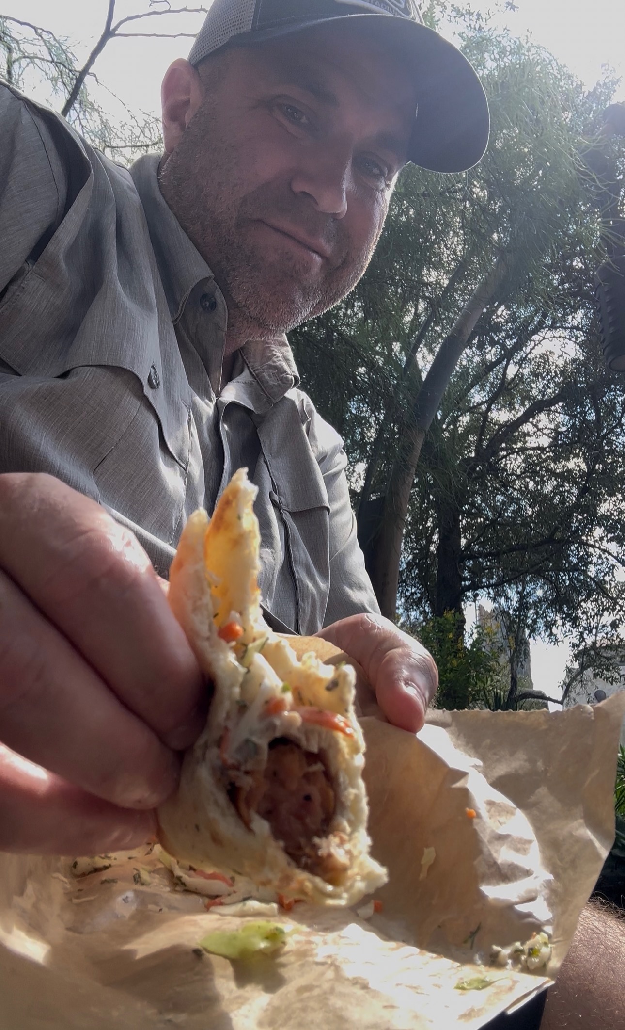 Ryan with a bitten lunch Ronto Wrap at Ronto Roasters
