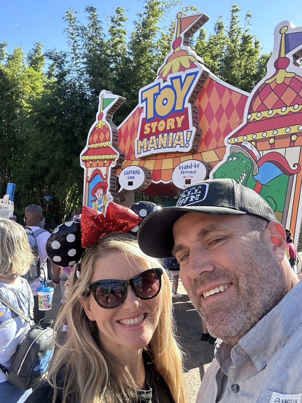 Ryan and Sarah smiling in front of the Toy Story Mania entrance