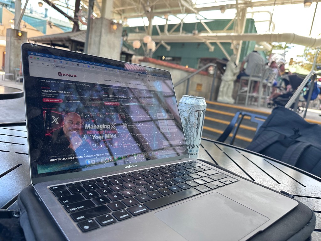 MacBook and a Monster at a shaded table during the work session
