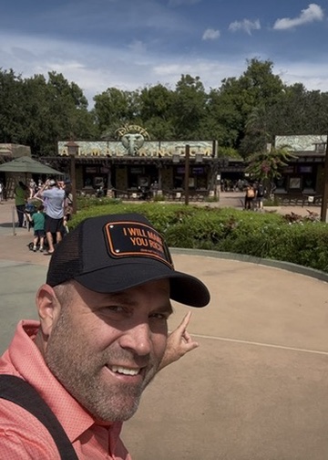 Ryan pointing at the Animal Kingdom entrance sign