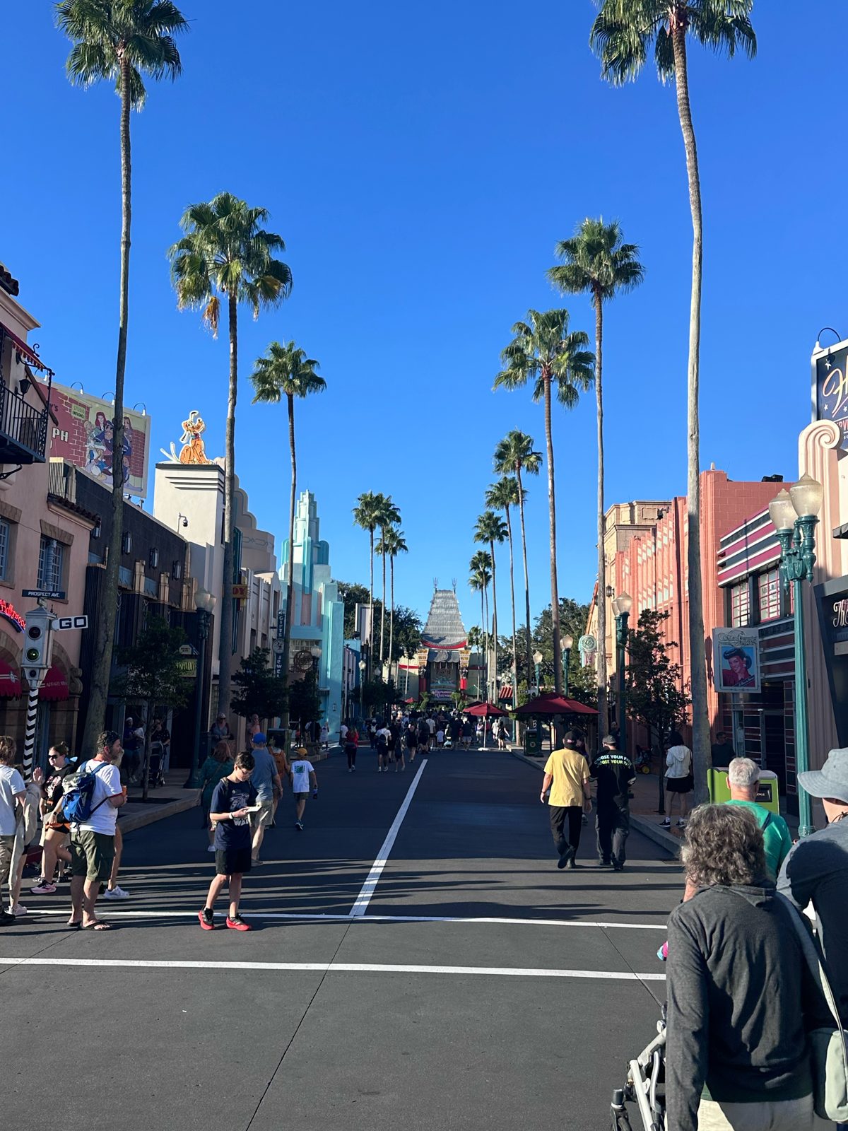 Hollywood Boulevard lined with palm trees on a clear morning, light crowds