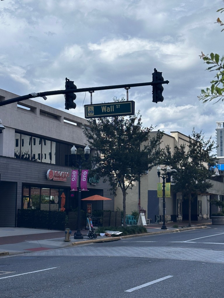 Wall Street corner with DTO banners near Mecatos Bakery in downtown Orlando