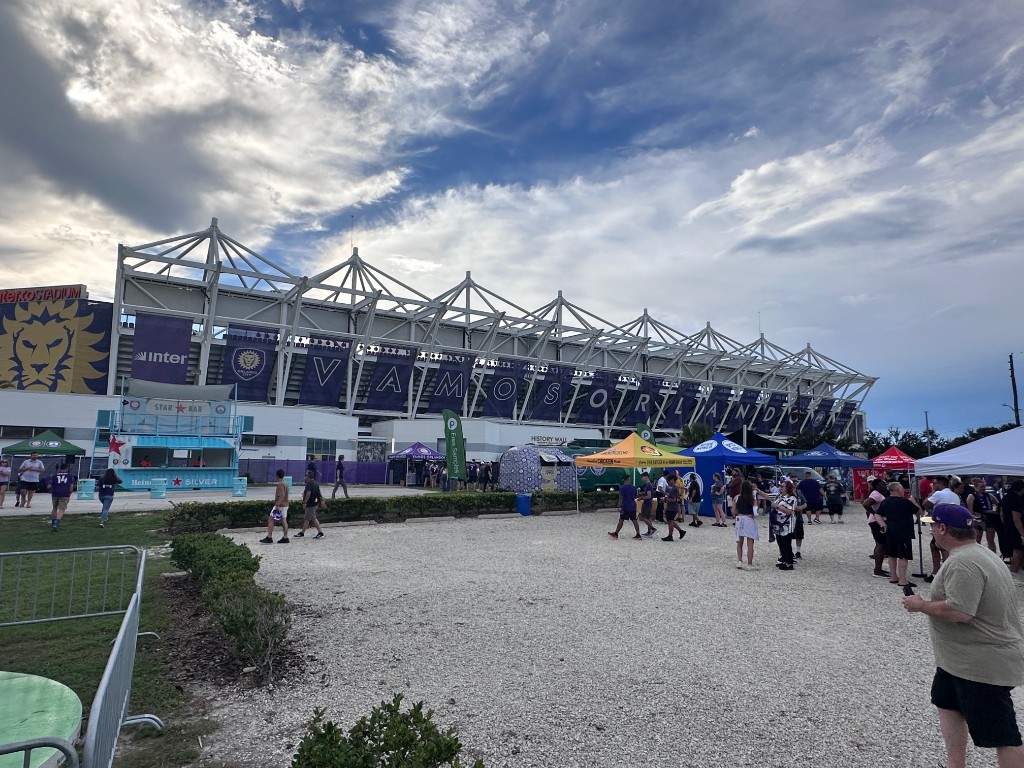 Fan fest plaza with VAMOS ORLANDO banners on the stadium