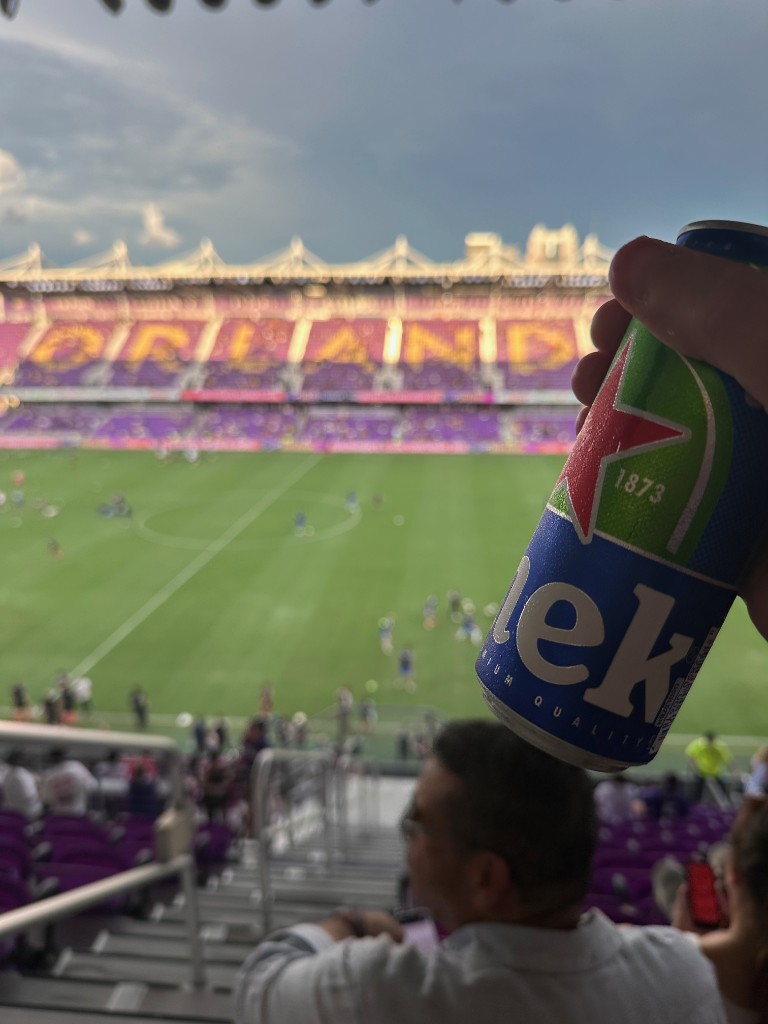 Heineken above purple seats overlooking the pitch