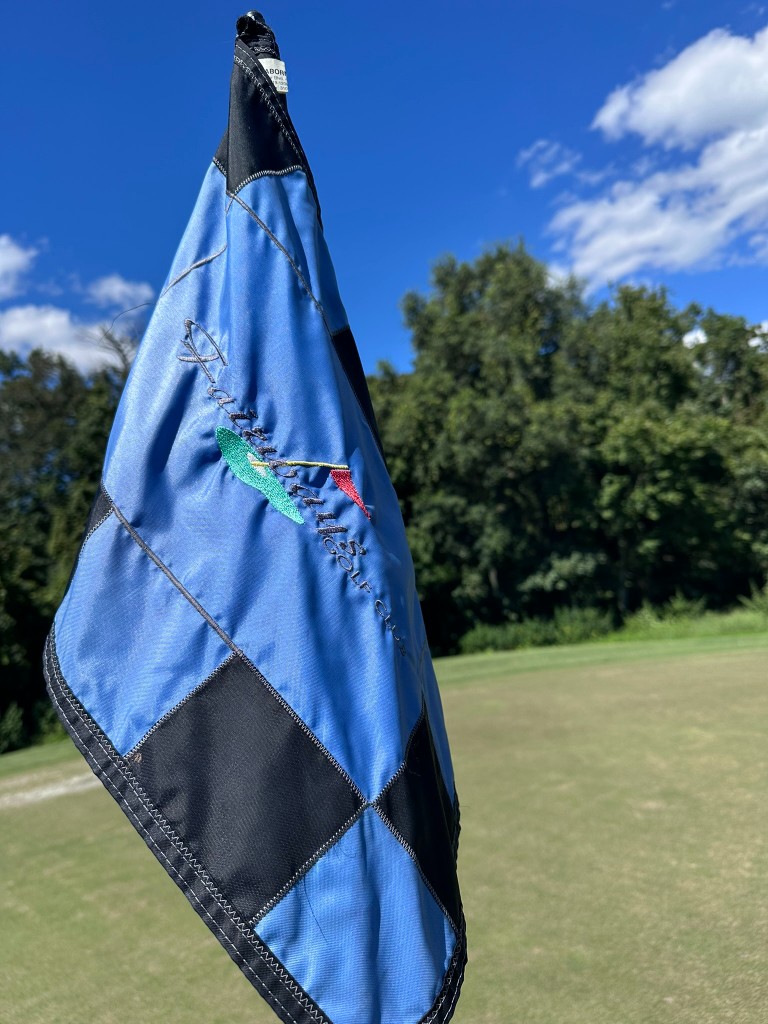 Fairways Golf Club pin flag against blue sky