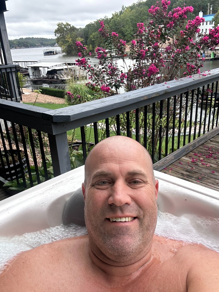 Ryan in the hot tub overlooking Lake of the Ozarks docks