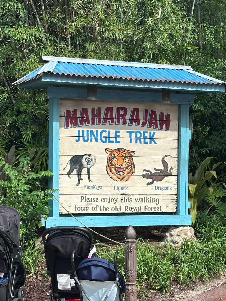 Maharajah Jungle Trek entrance sign with monkeys, tigers, and dragons