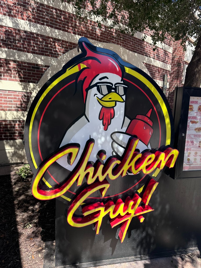 Chicken Guy! circular logo sign with the sunglasses chicken