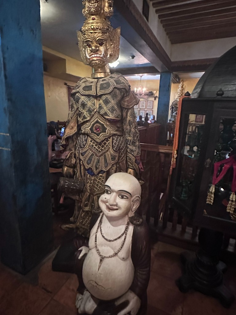 Guardian and laughing Buddha statues on the second floor
