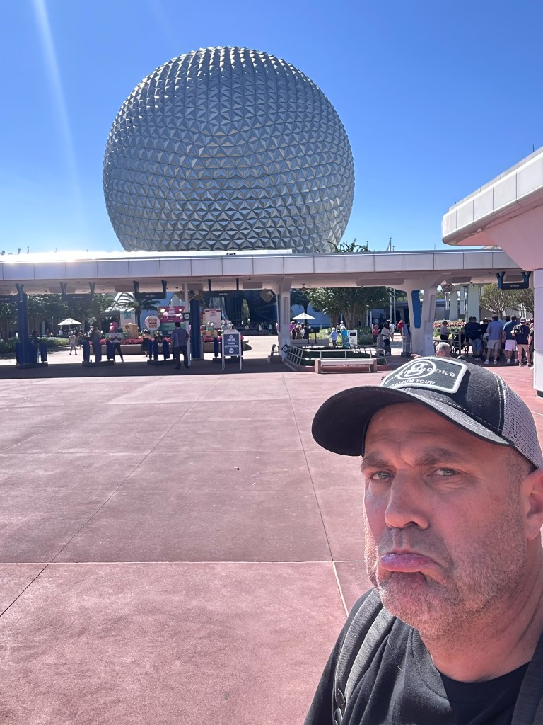 Ryan making a sad face in front of Spaceship Earth after the EPCOT blackout denial