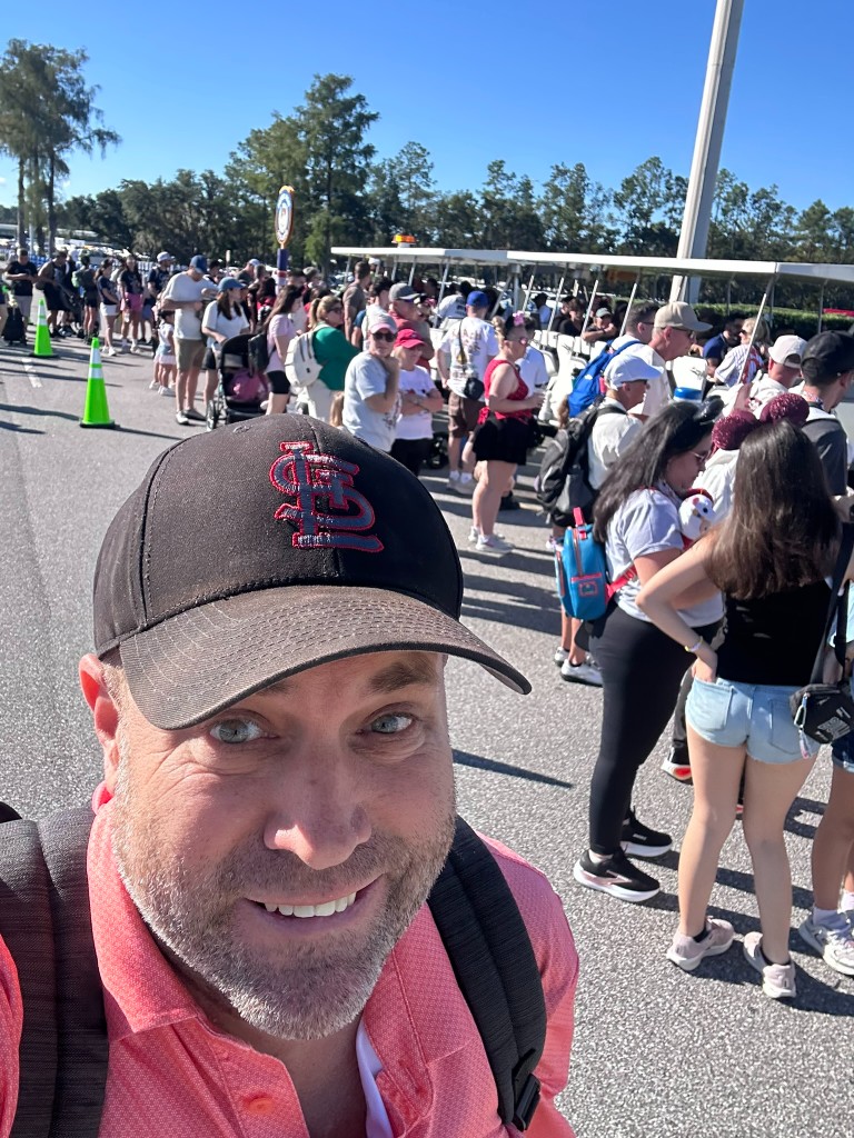 Ryan in the Magic Kingdom parking tram queue on a sunny October day