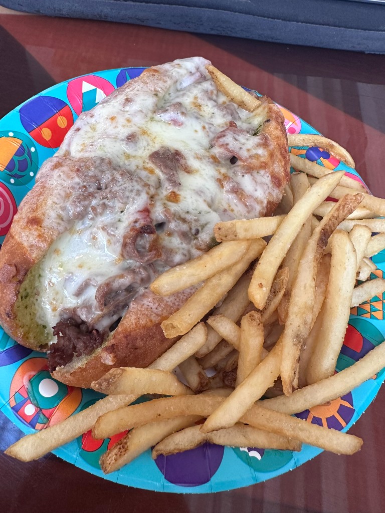 Roast beef sub and fries from Contempo Café on a Disney plate