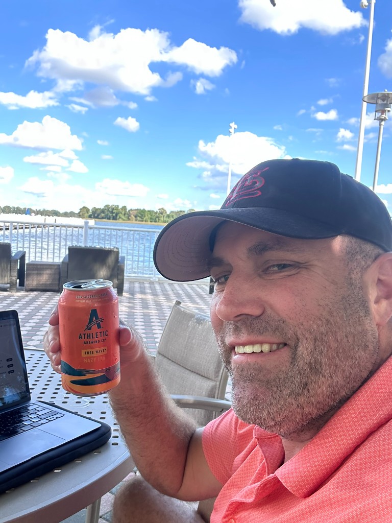Ryan cheering with Athletic Brewing Free Wave NA IPA at the Contemporary lake patio