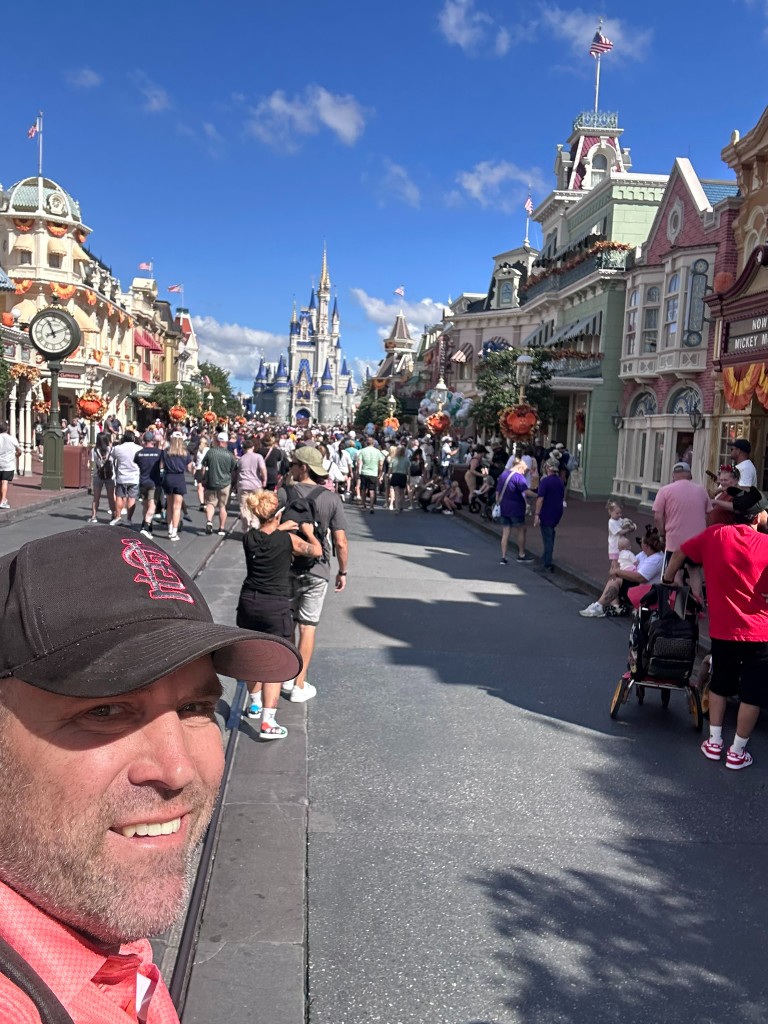 Ryan on Main Street with Cinderella Castle behind him during a Magic Kingdom work scout