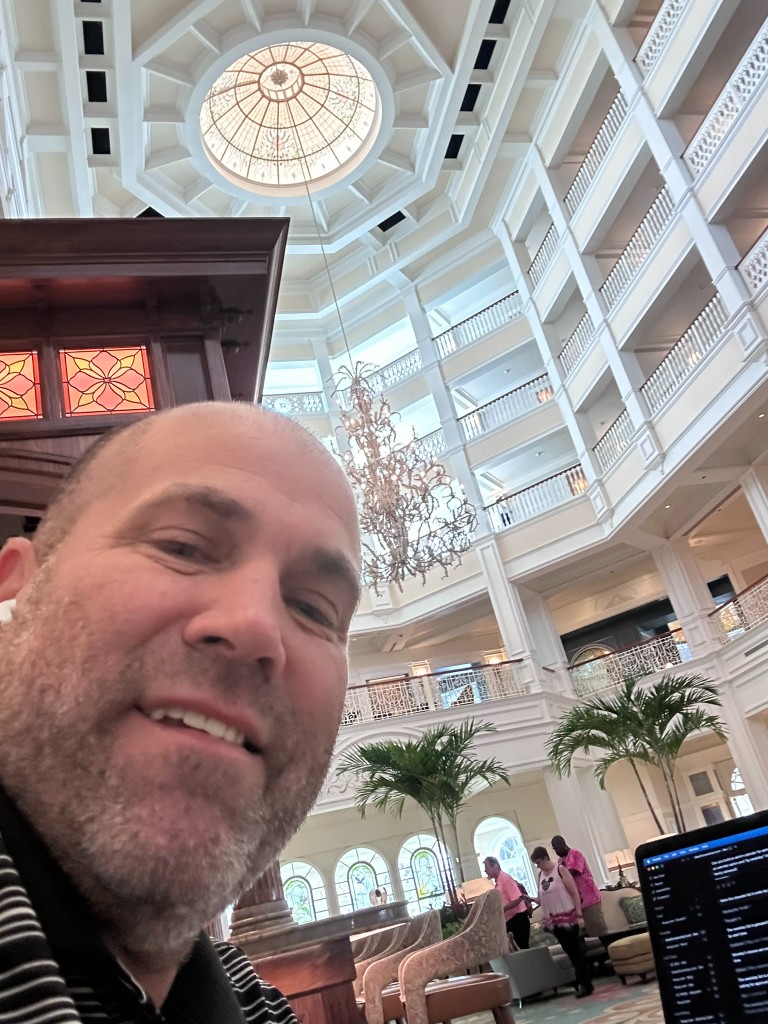 Ryan working in the Grand Floridian lobby under the stained-glass dome