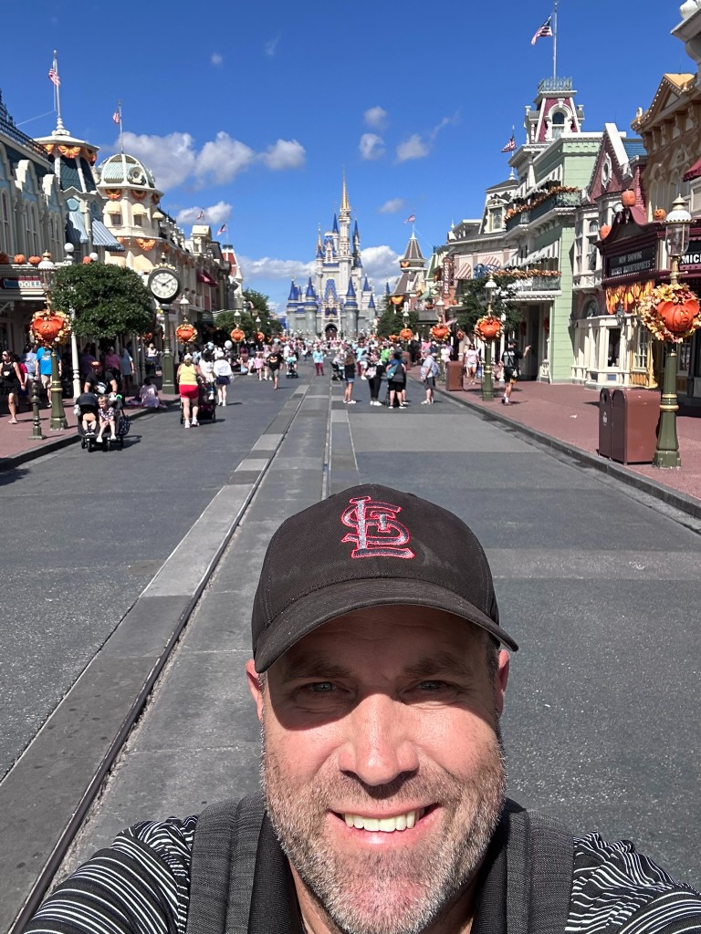 Ryan on Main Street with Halloween Mickey wreaths and Cinderella Castle