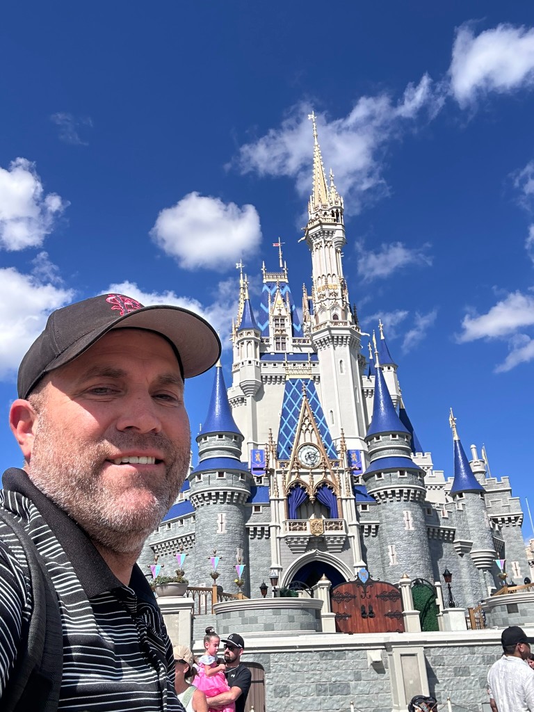 Ryan in front of Cinderella Castle during a quieter Halloween-party daytime visit