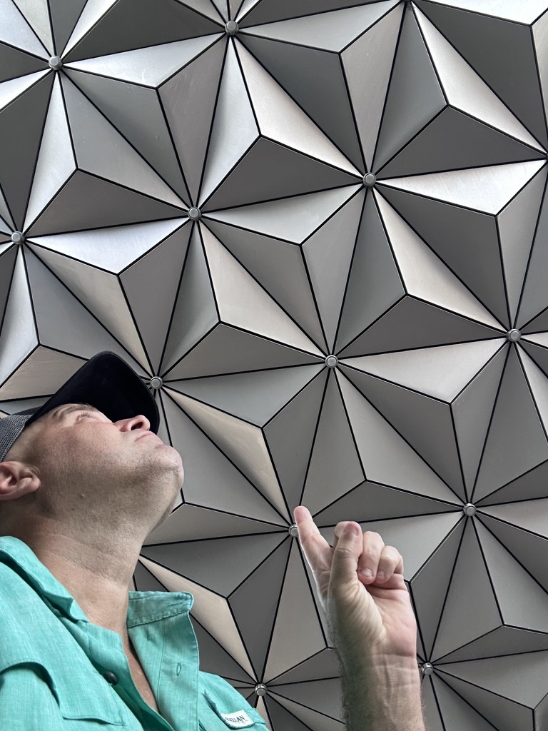 Ryan pointing up at the Spaceship Earth geodesic panels