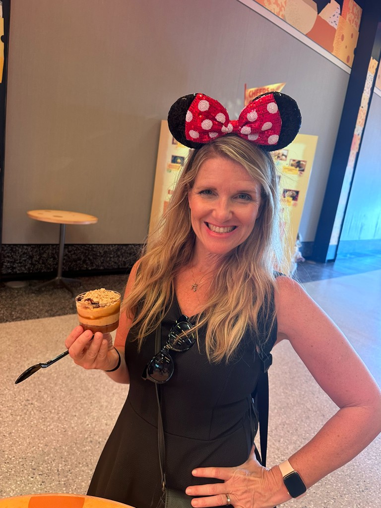 Sarah holding the Pumpkin Cheesecake Mousse Trifle indoors