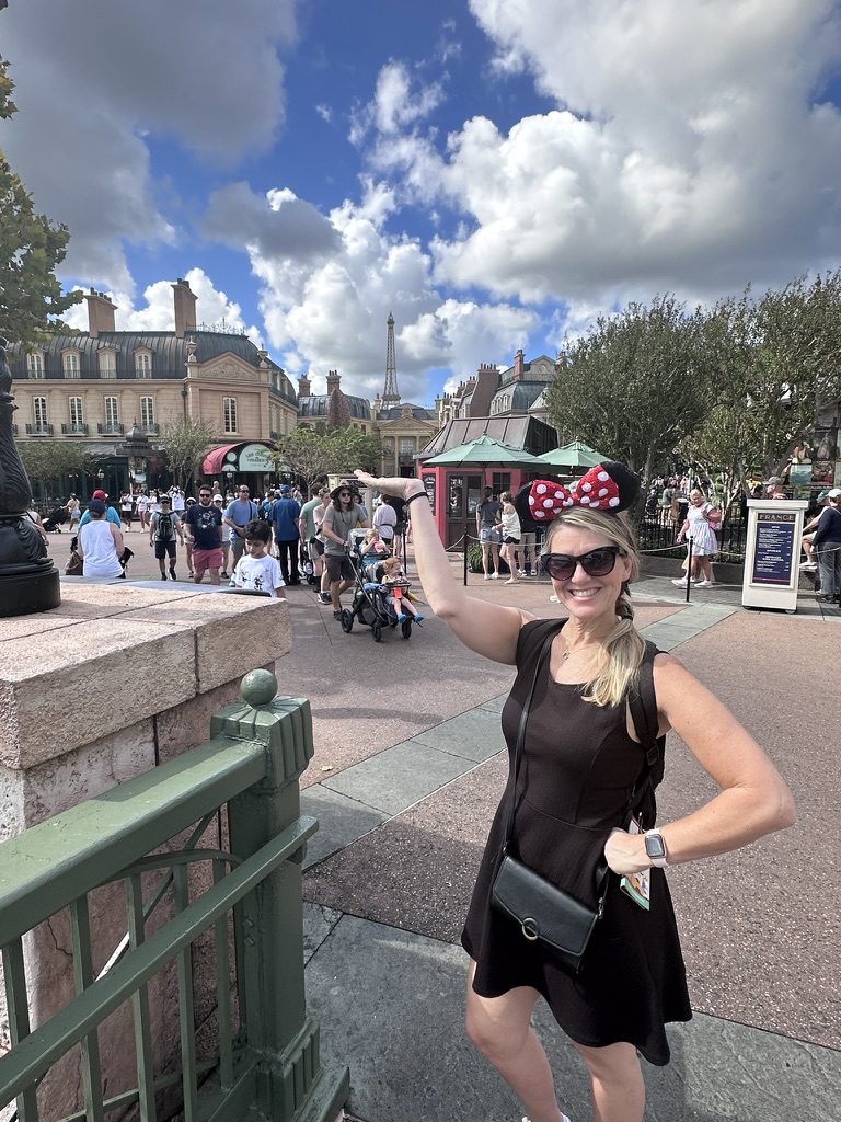Sarah posing with the France Pavilion Eiffel Tower