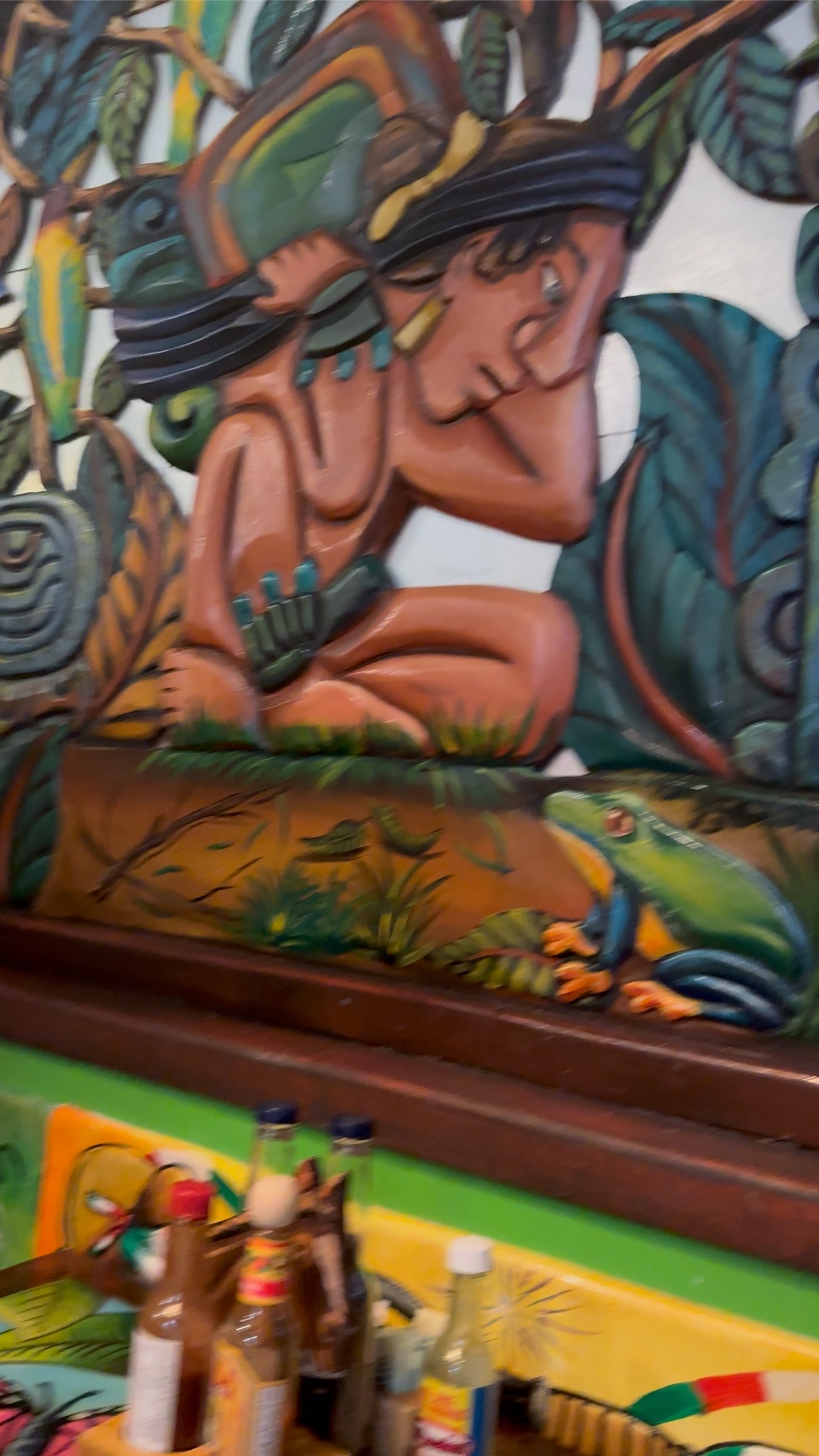 Carved wall art and painted table at Fiesta Cancún