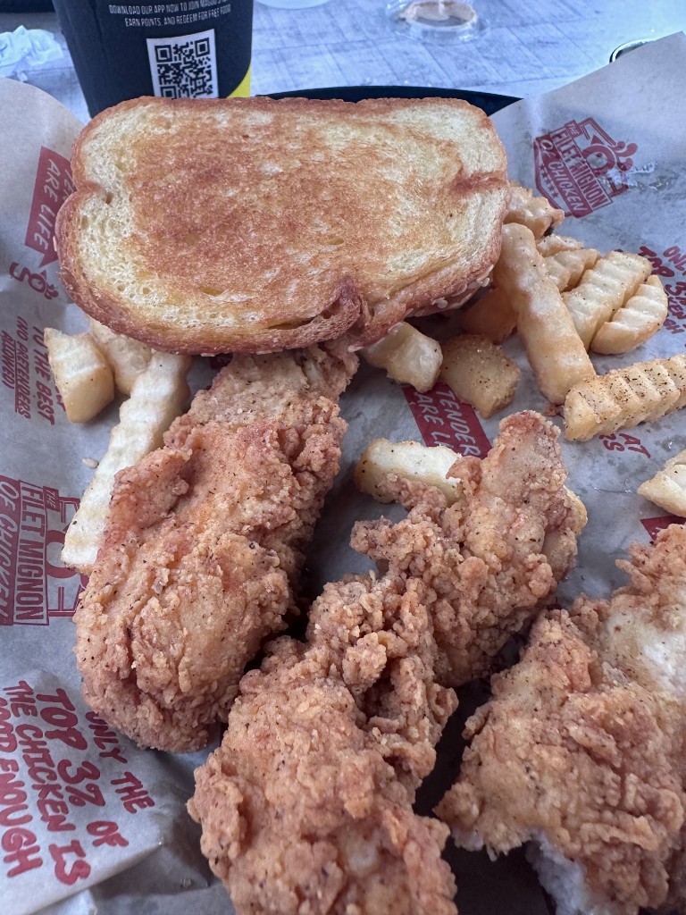 Chicken tenders, Texas toast, and fries in a Huey Magoo's basket