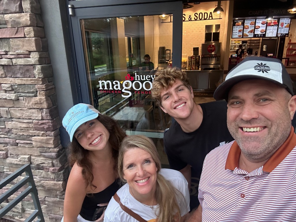 Ryan, Sarah, and family outside Huey Magoo's Chicken Tenders in Lake Nona