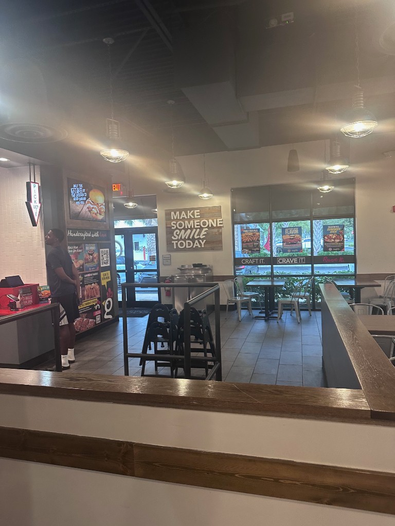 Pickup counter and dining area inside Huey Magoo's Lake Nona