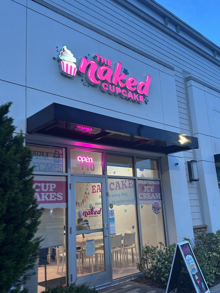 The Naked Cupcake storefront in Lake Nona at night