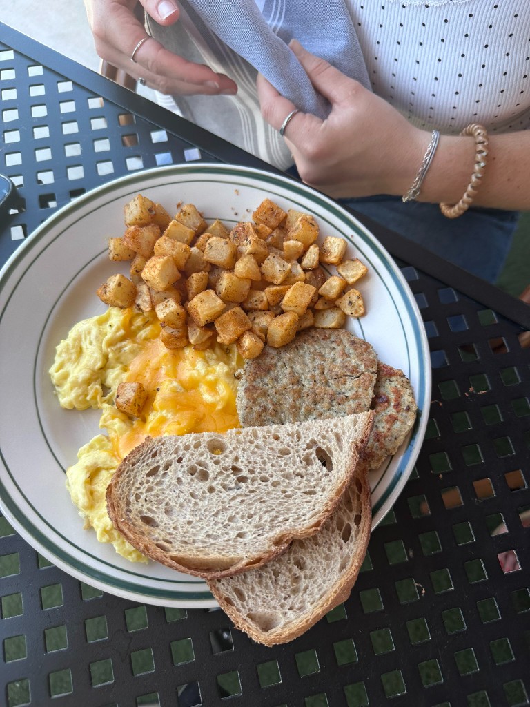 Scrambled eggs, home fries, sausage patties, and toast