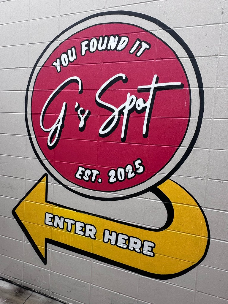 G's Spot mural with Enter Here arrow