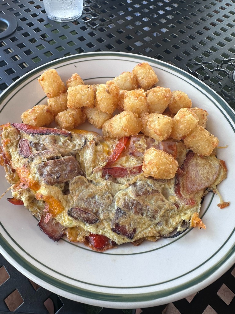Omelet with tater tots on the patio table