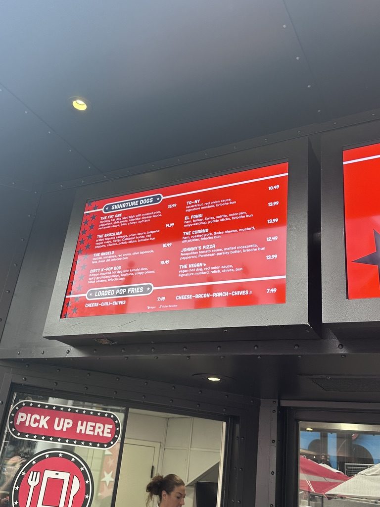 Fat One's signature dogs and loaded pop fries menu board