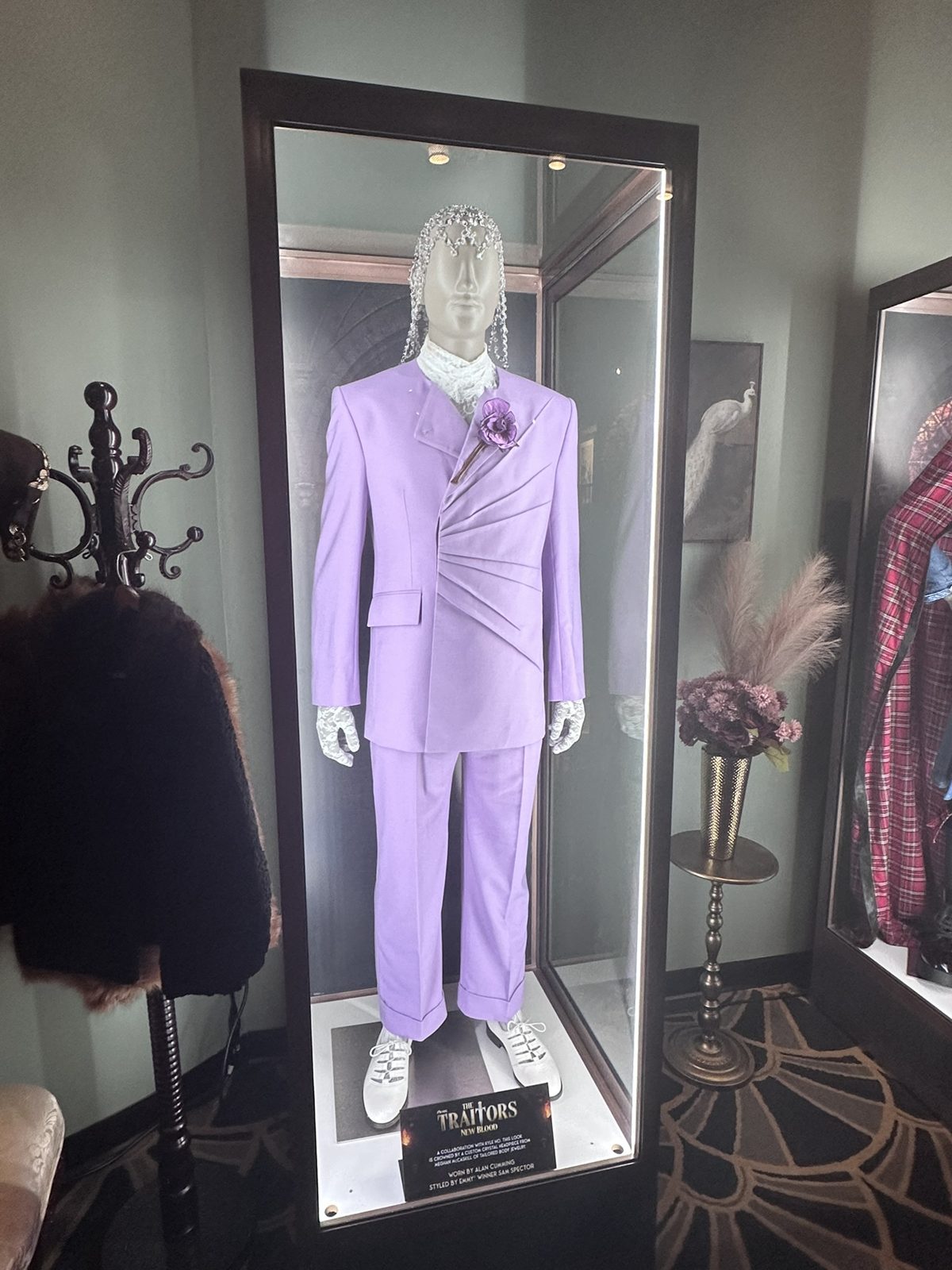 Lavender suit worn by host Alan Cumming