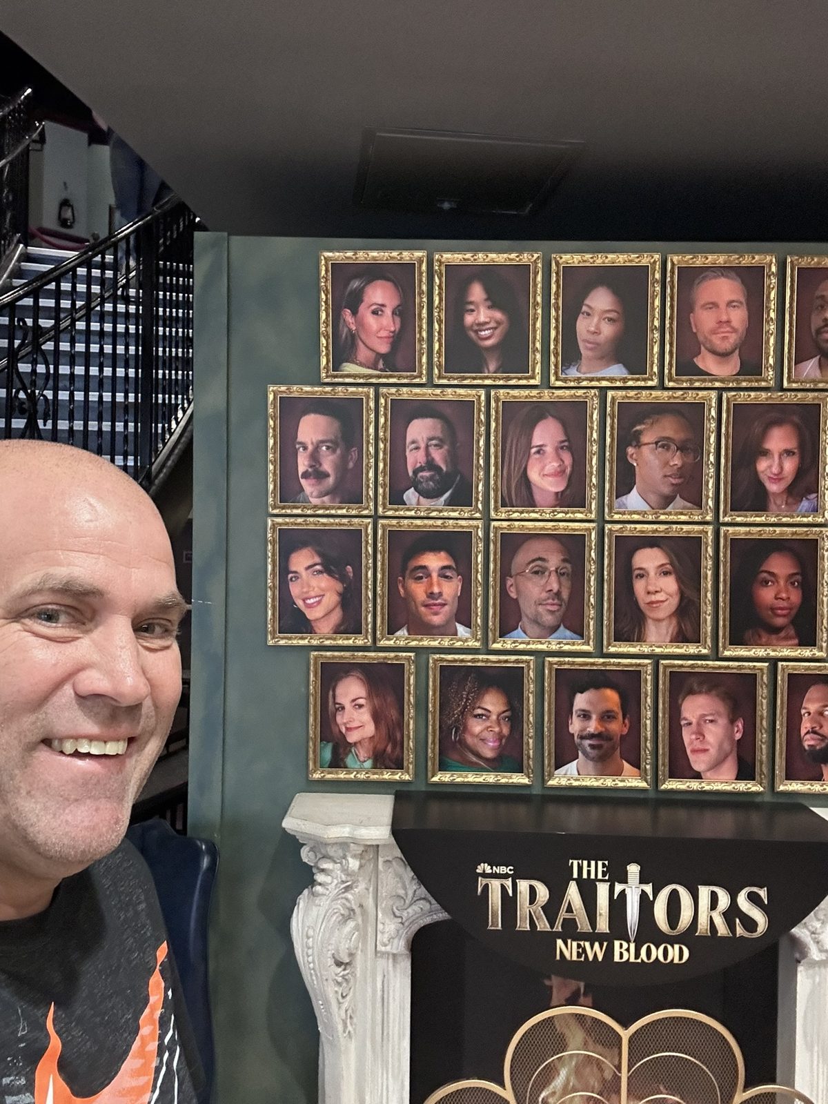 Ryan at the framed cast portrait wall