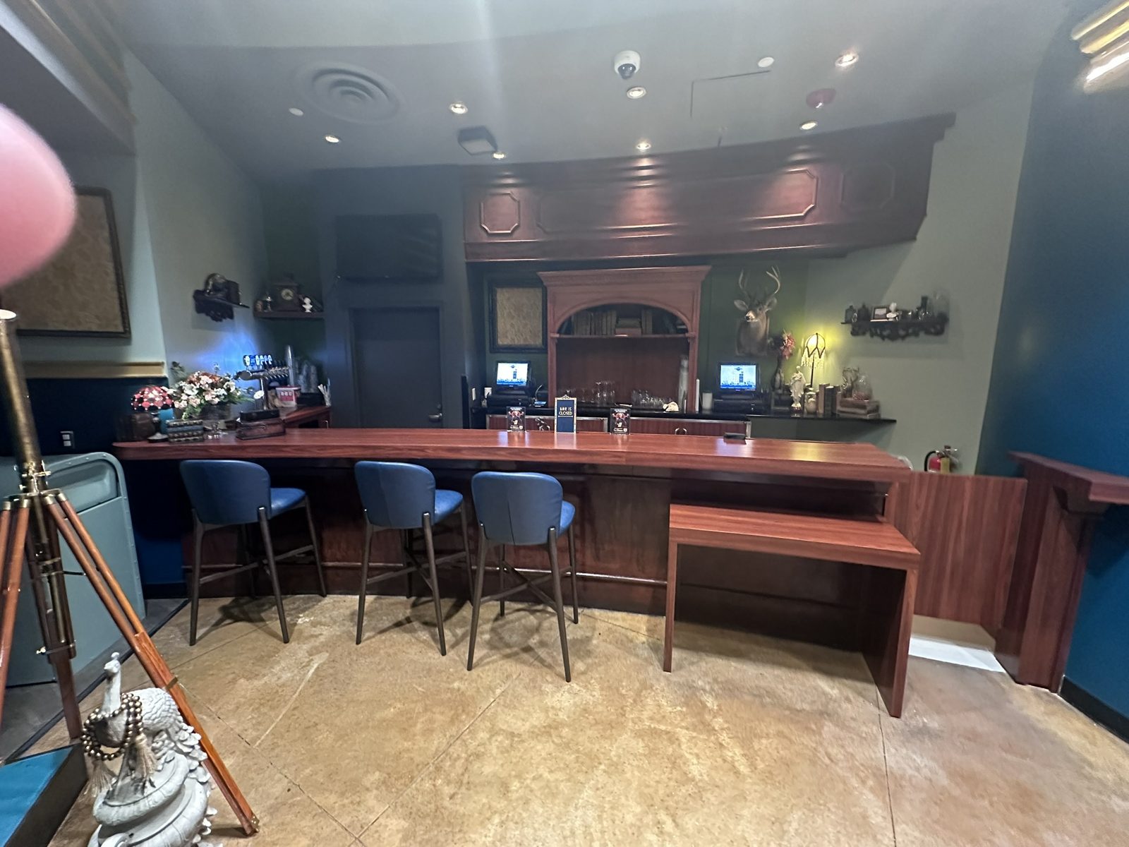 Closed downstairs bar with blue stools and a bar is closed sign