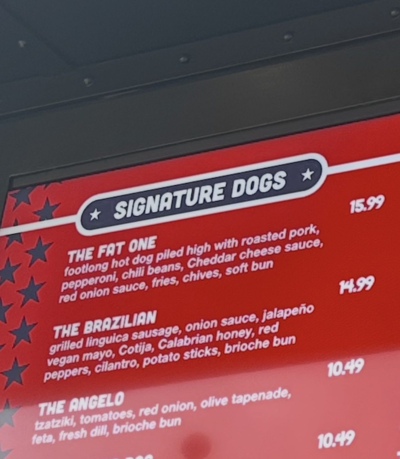 Close-up of the Fat One's signature dogs menu with The Fat One at $15.99